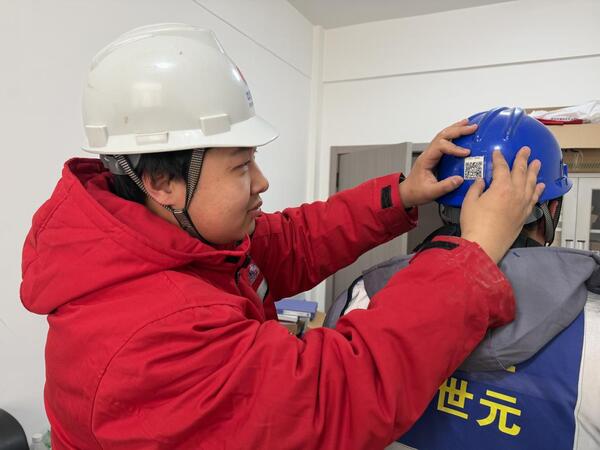 2-1、项目安全员为施工人怨爻贴二维码.jpg 2-1、项目安全员为施工人怨爻贴二维码.jpg